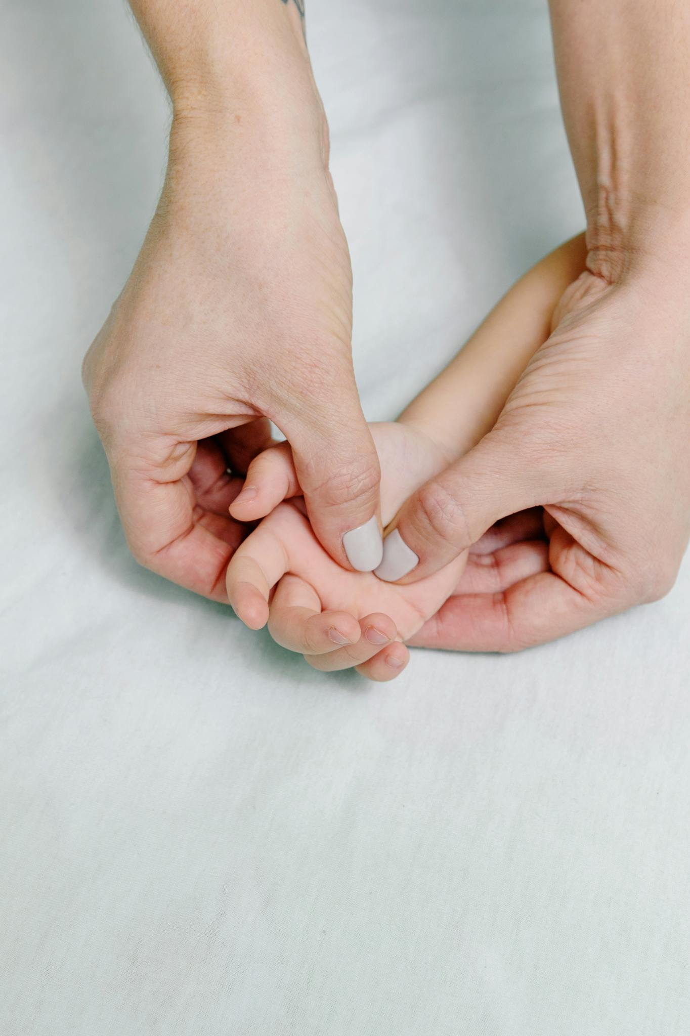 Soothing hand massage for a child's relaxation, conveying tender care and connection.